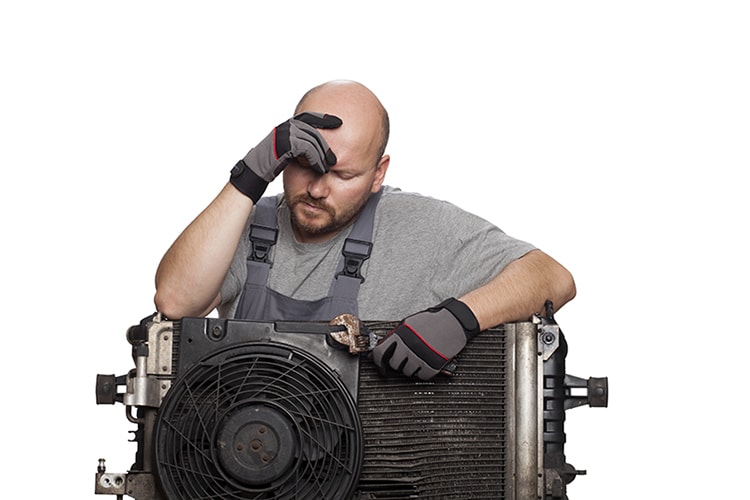 A 40-year-old man is a AC mechanic holding an old damaged AC